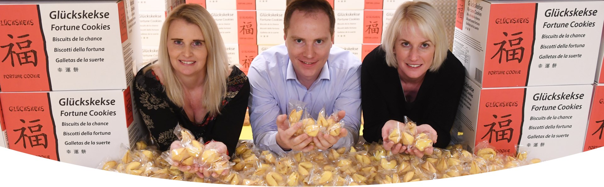 Alexandra, Christoph and Viktoria Brauch surrounded by fortune cookies.