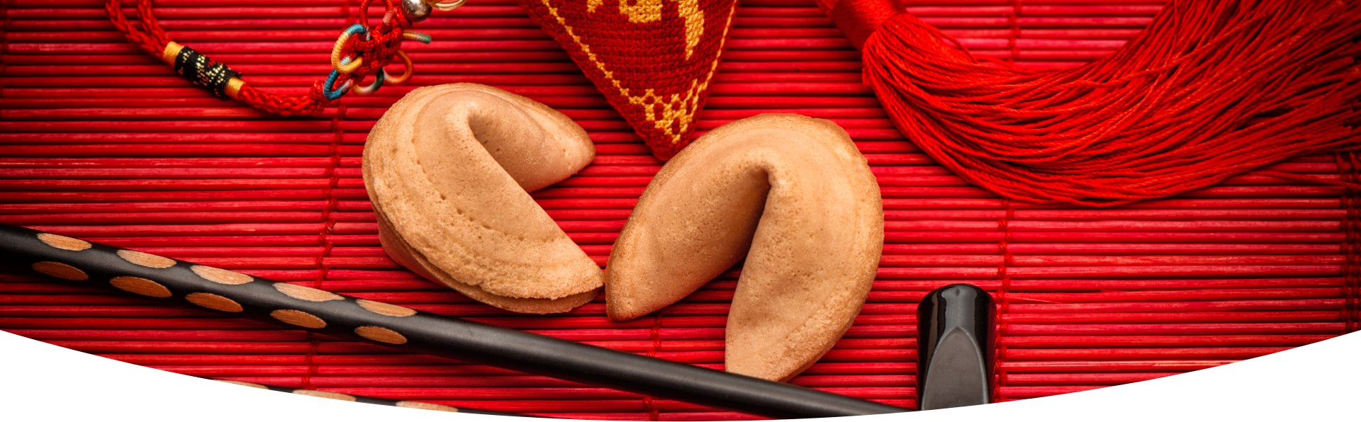 2 fortune cookies with an Asian decoration in red